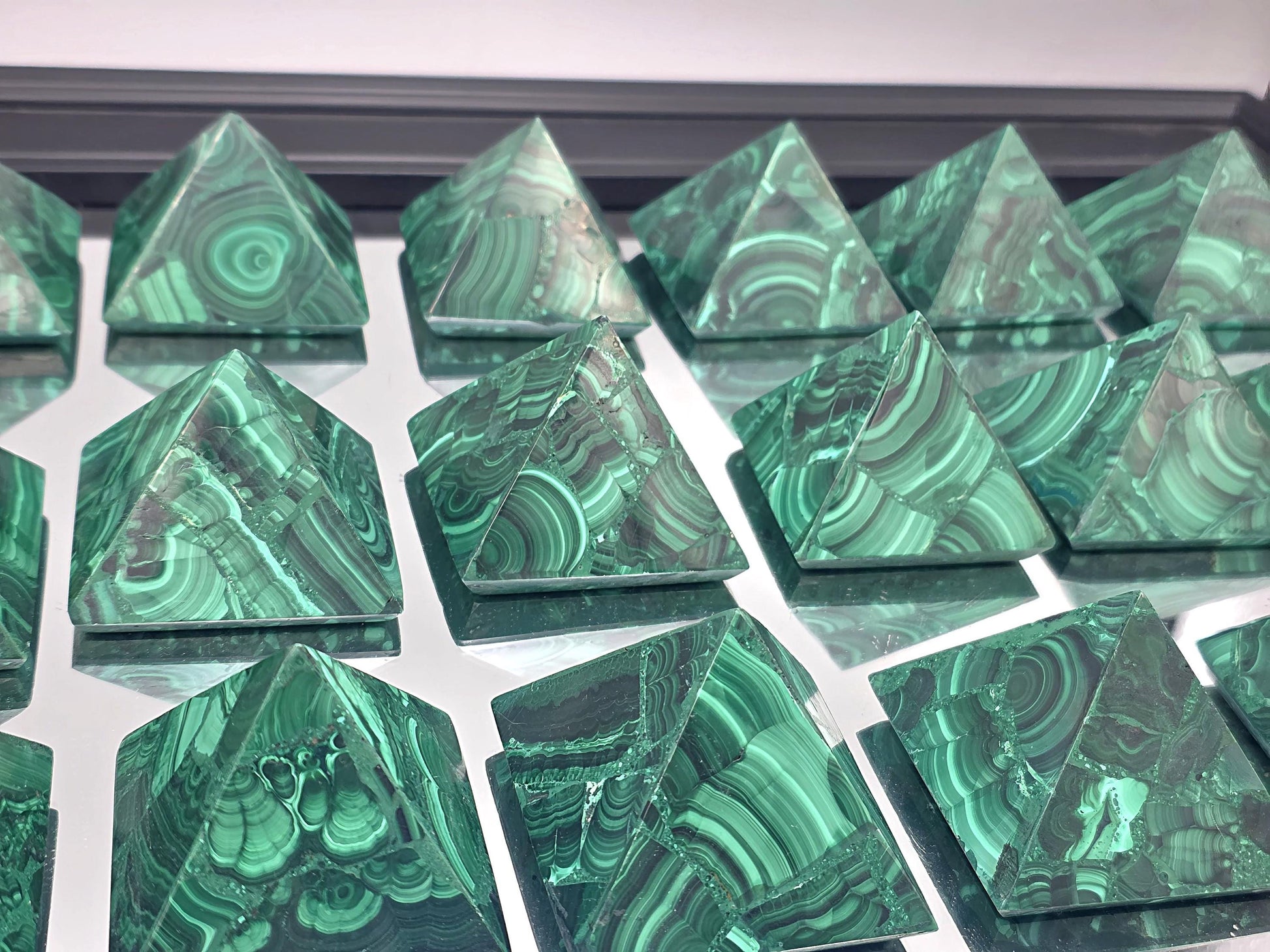 Polished malachite pyramid with rich green banding