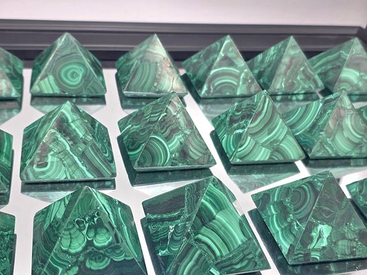 Polished malachite pyramid with rich green banding