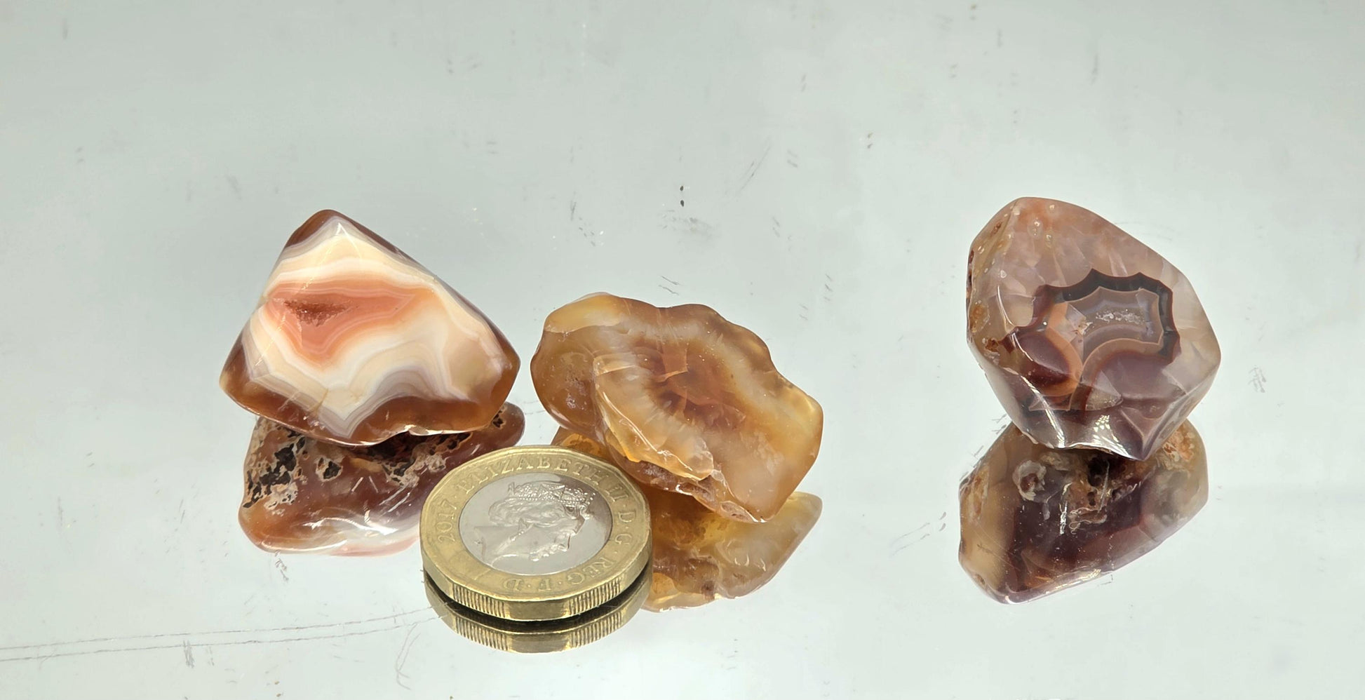 Small Malawi Agate tumbled crystal with natural banding and a polished finish.