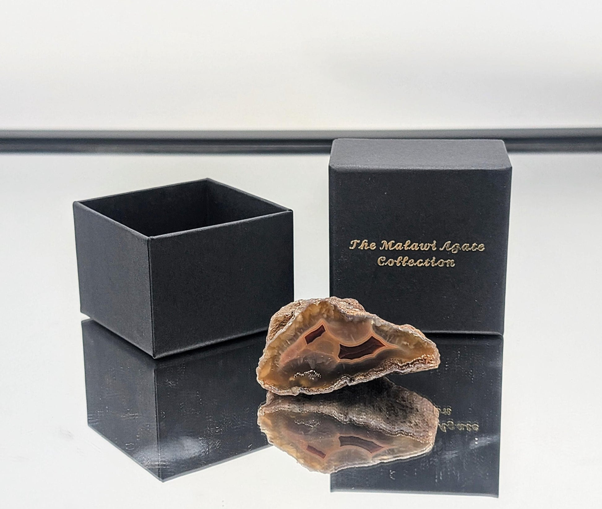 A stunning Malawi Agate crystal gemstone set with natural banding and deep colors.