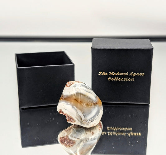 Malawi agate crystal stone with a stunning polished surface and vibrant yellow hues.