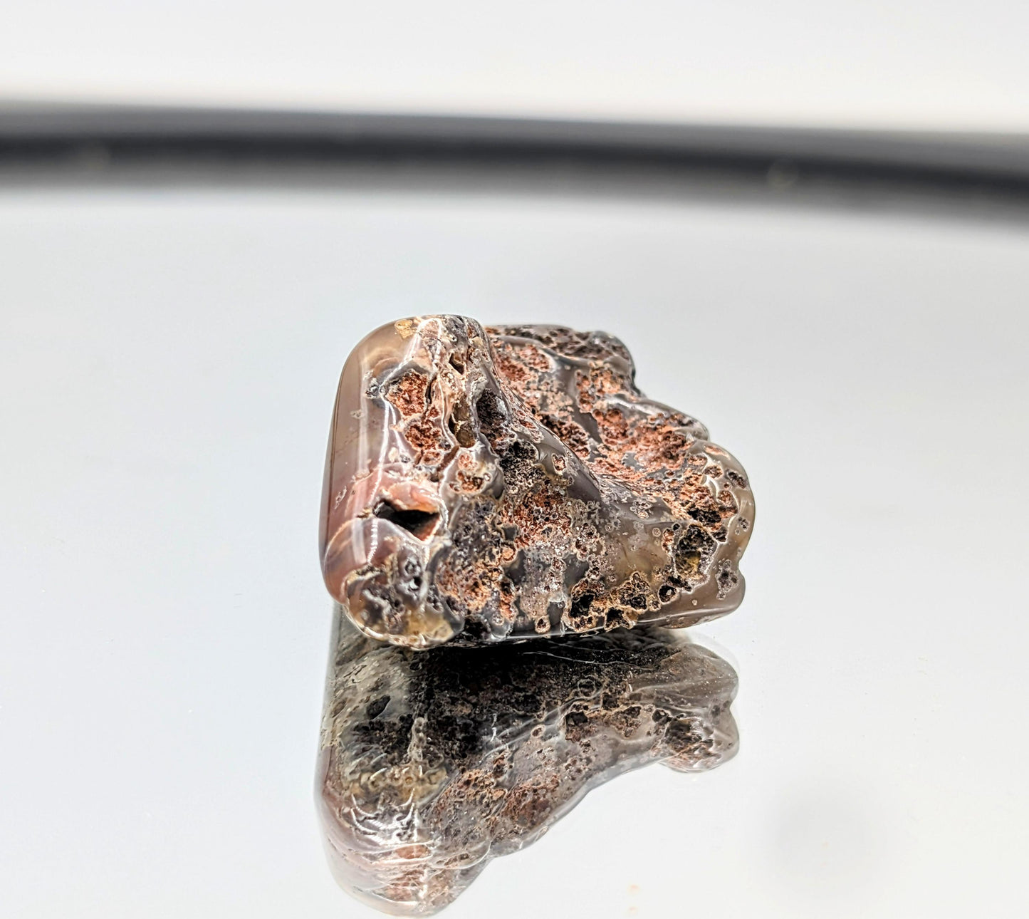 Compact Malawi Agate crystal in tumble form.