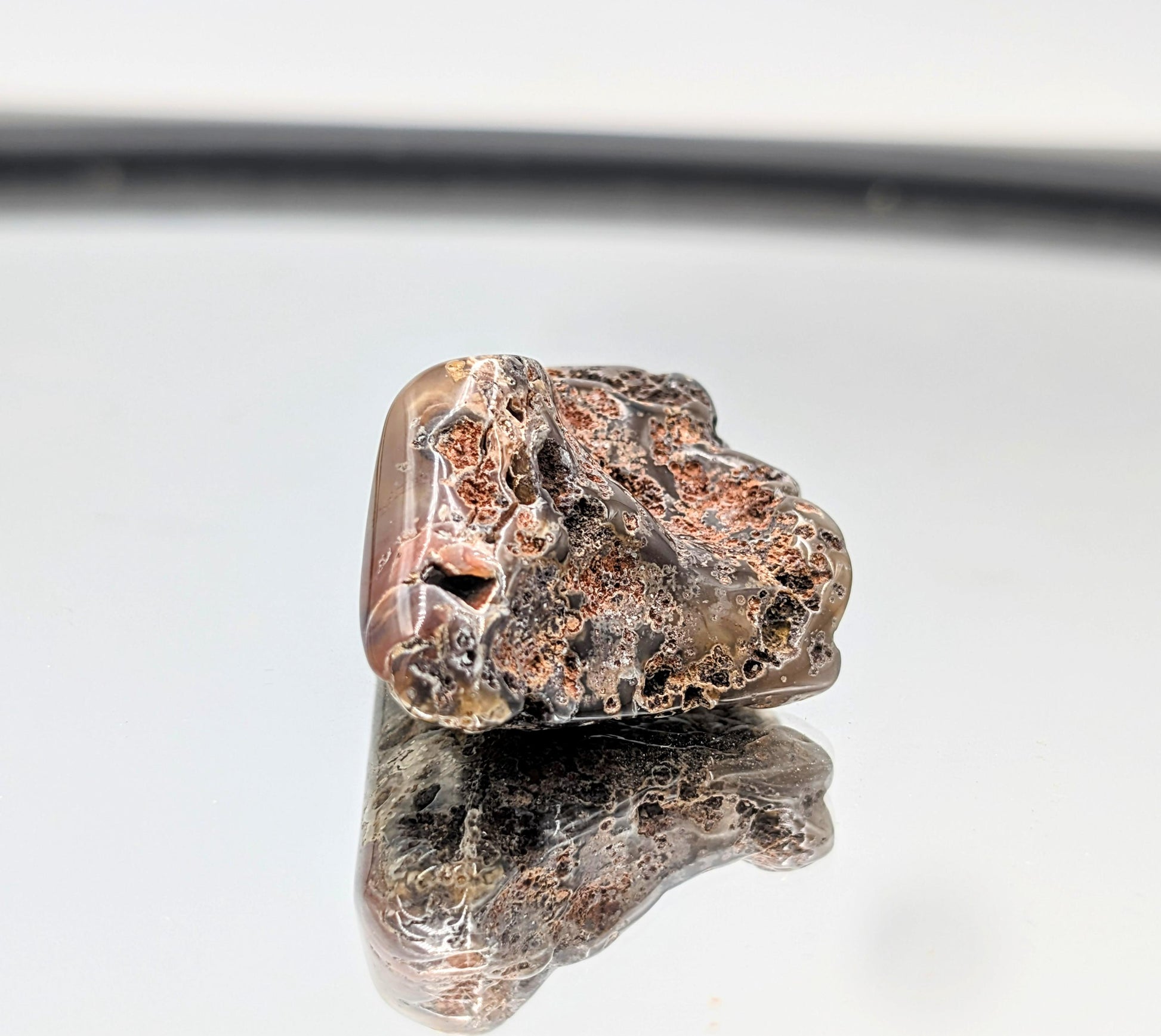 Compact Malawi Agate crystal in tumble form.