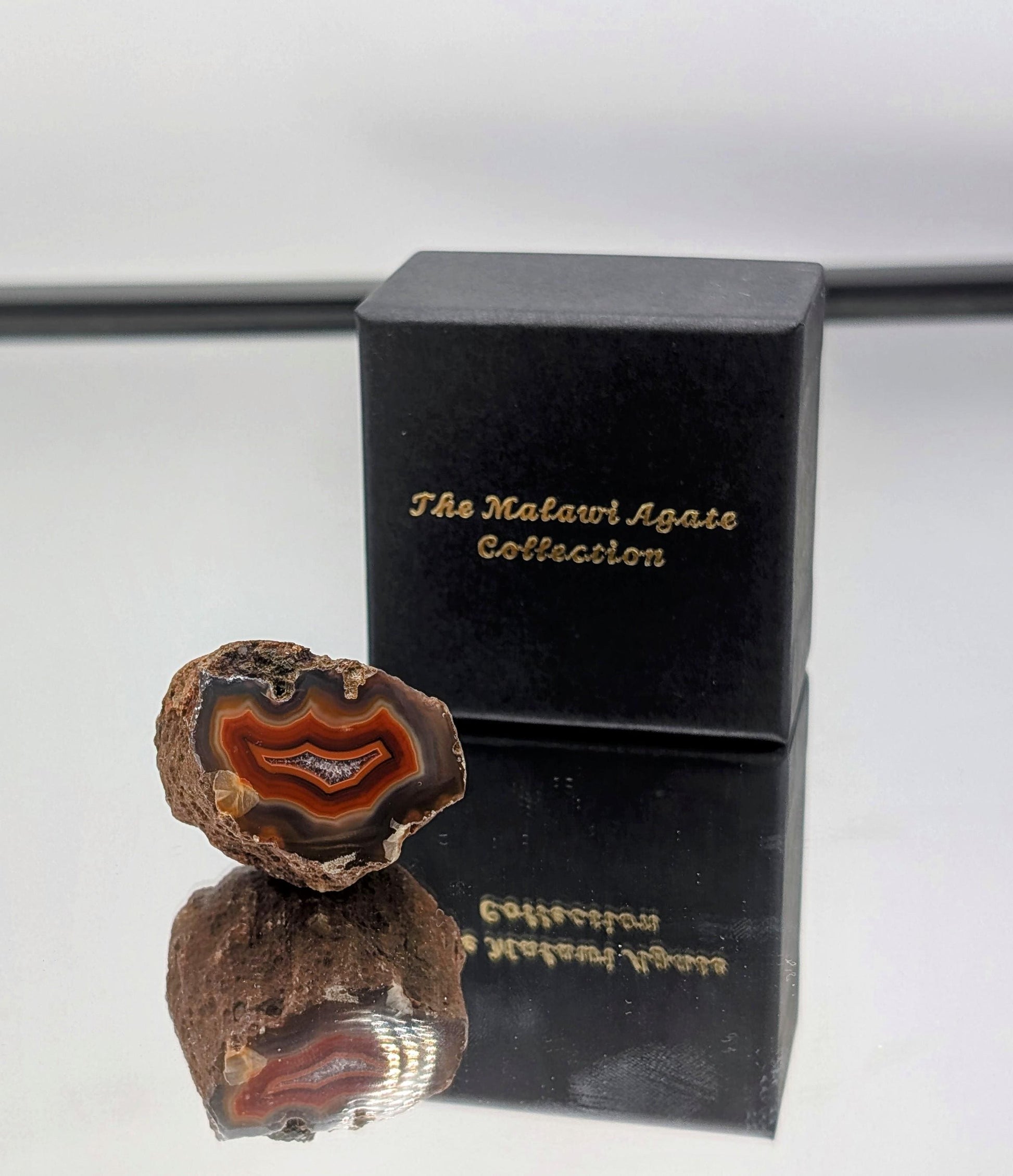 Natural polished Malawi Agate stones with intricate banding and vivid colors.