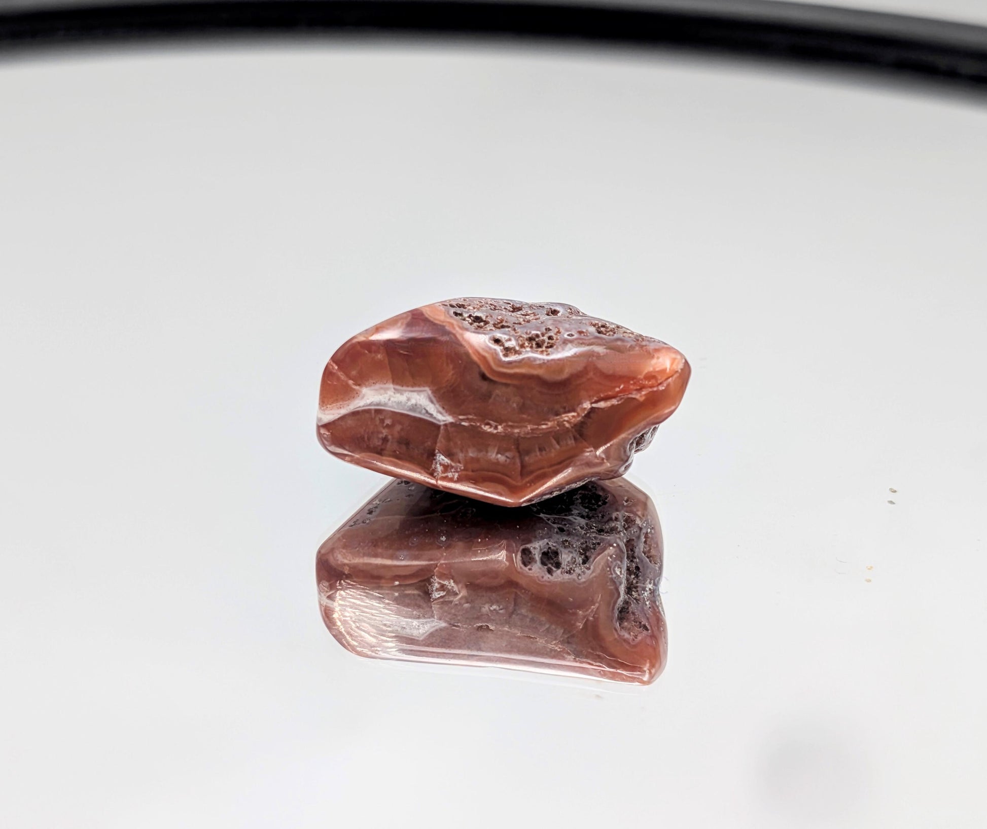 Polished Malawi Agate tumble stone with soft, natural banding.