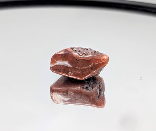 Polished Malawi Agate tumble stone with soft, natural banding.
