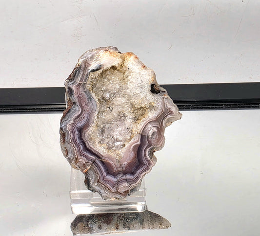 Mexican Agate Geode with polished edges and layered bands.