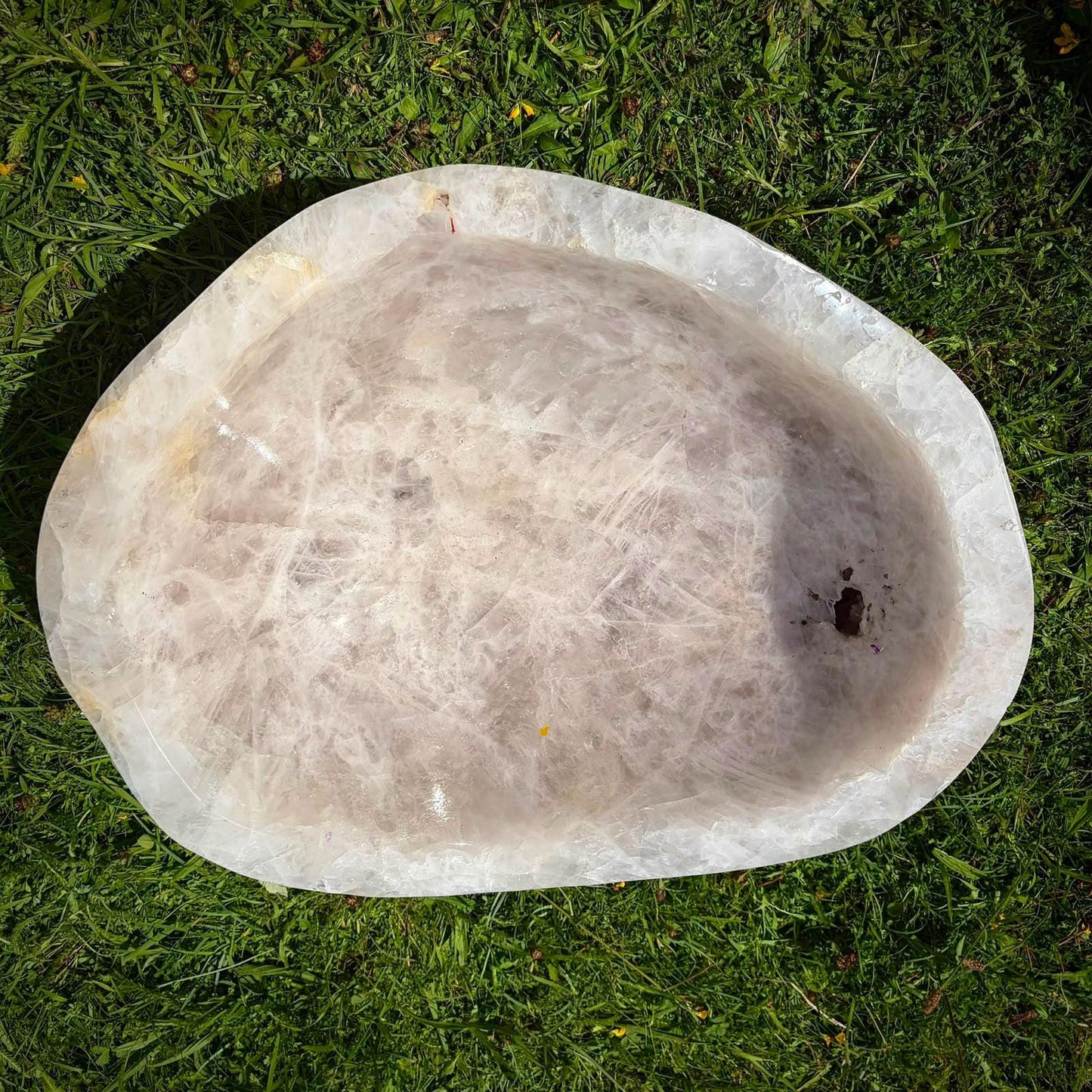 Hand-carved milky Quartz bowl displayed as a peaceful feature for a holistic interior space.