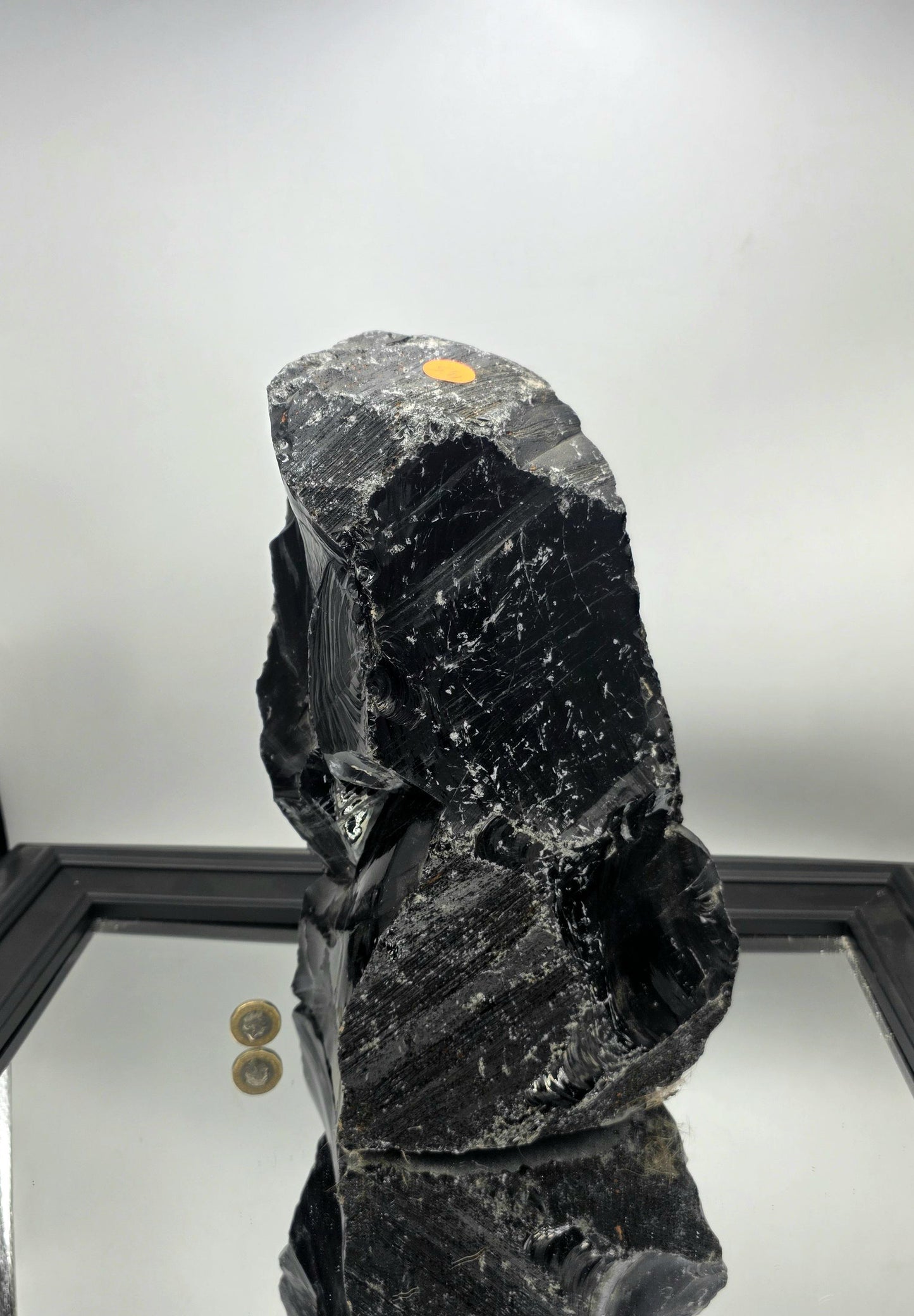 Large natural obsidian adding depth to a neutral-toned modern home interior.