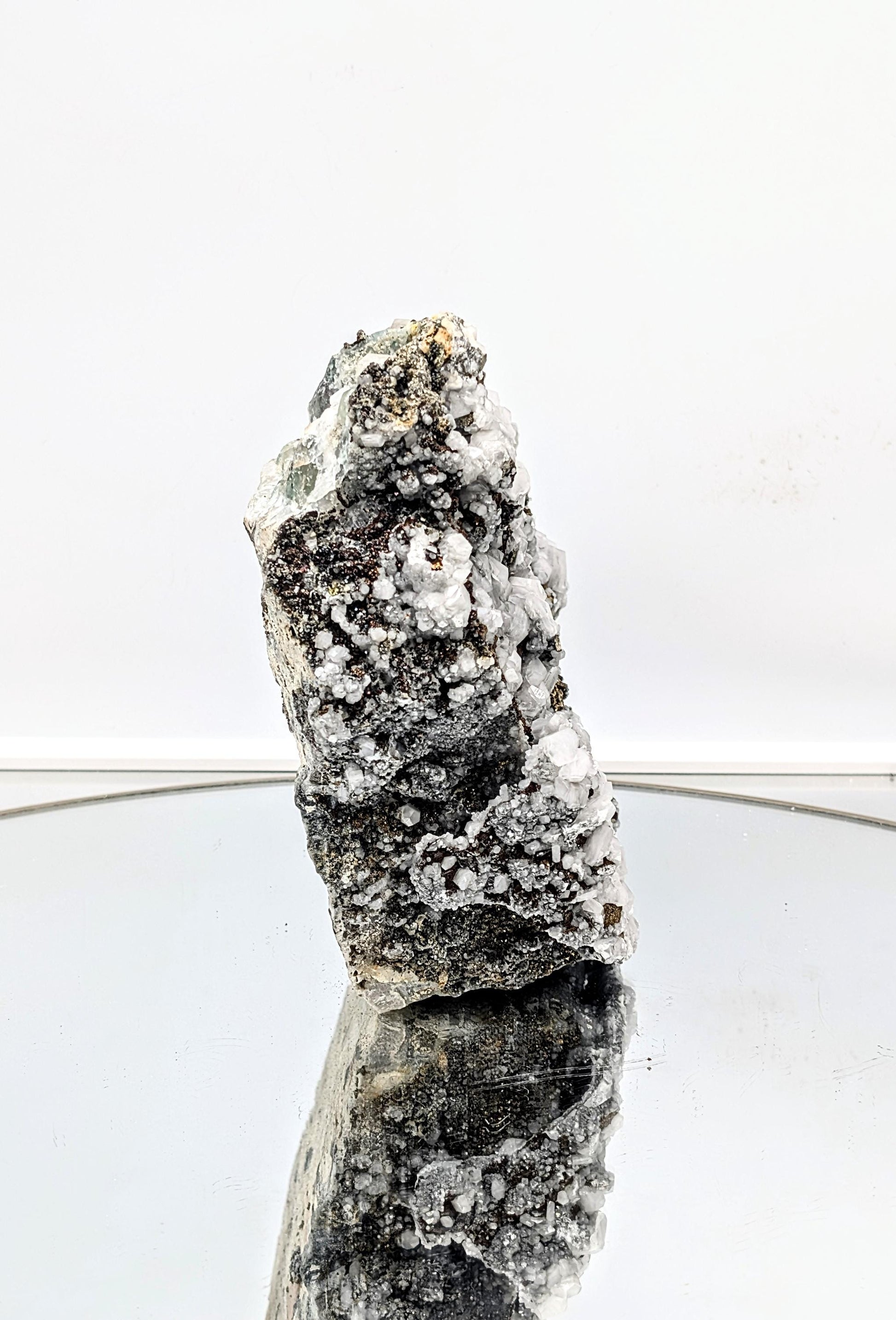 Natural chalcopyrite on fluorite crystal with calcite inclusions