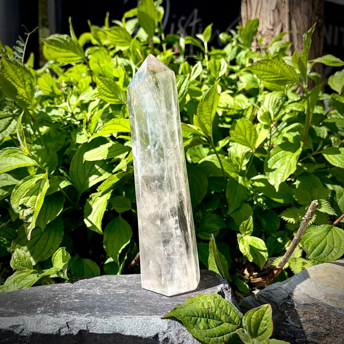 Natural clear quartz crystal point from Madagascar, polished into a refined tower shape.