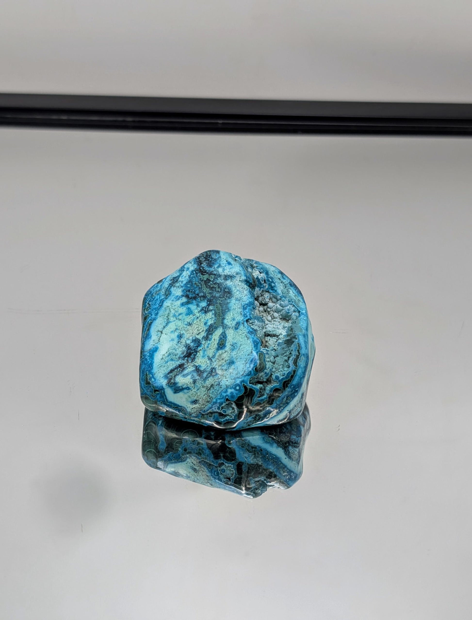 Natural freeform Malacolla crystal in deep green and blue tones.