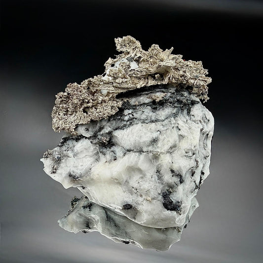 Native Silver associated with natural Calcite in a collectible mineral specimen.