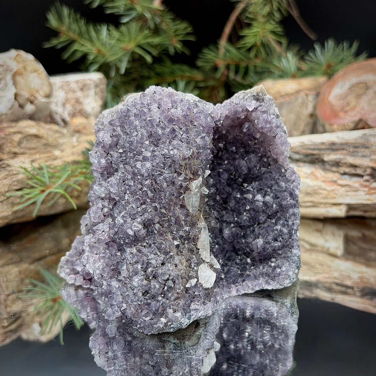 Decorative natural purple Amethyst specimen with exposed quartz crystals.