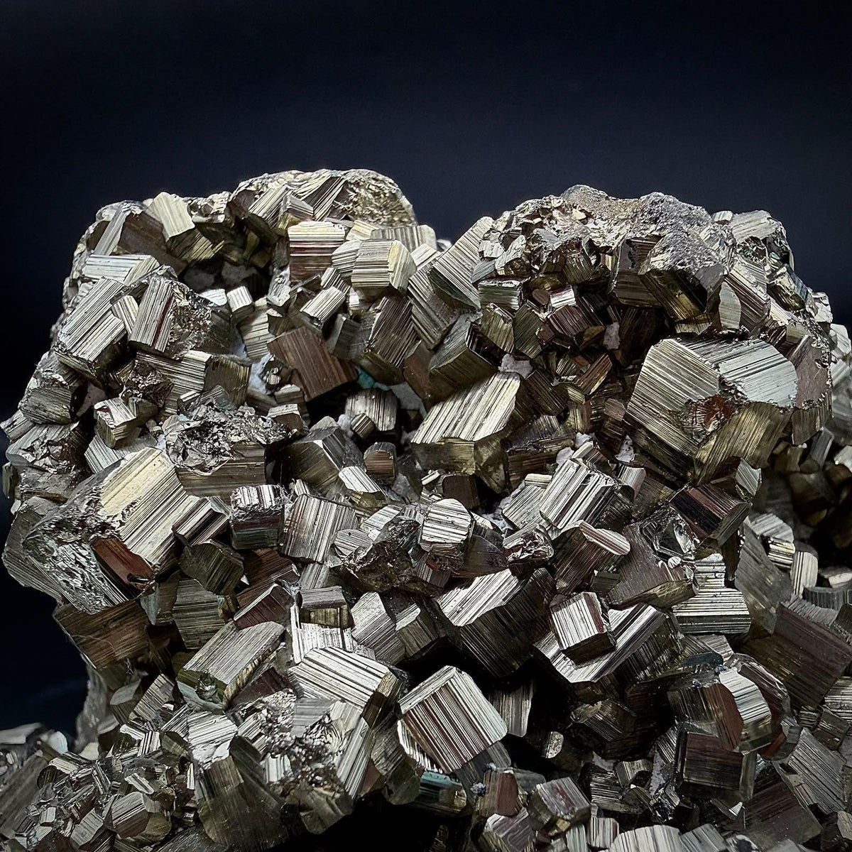 Detailed view of natural Pyrite crystals showing reflective metallic lustre and individual crystal faces.