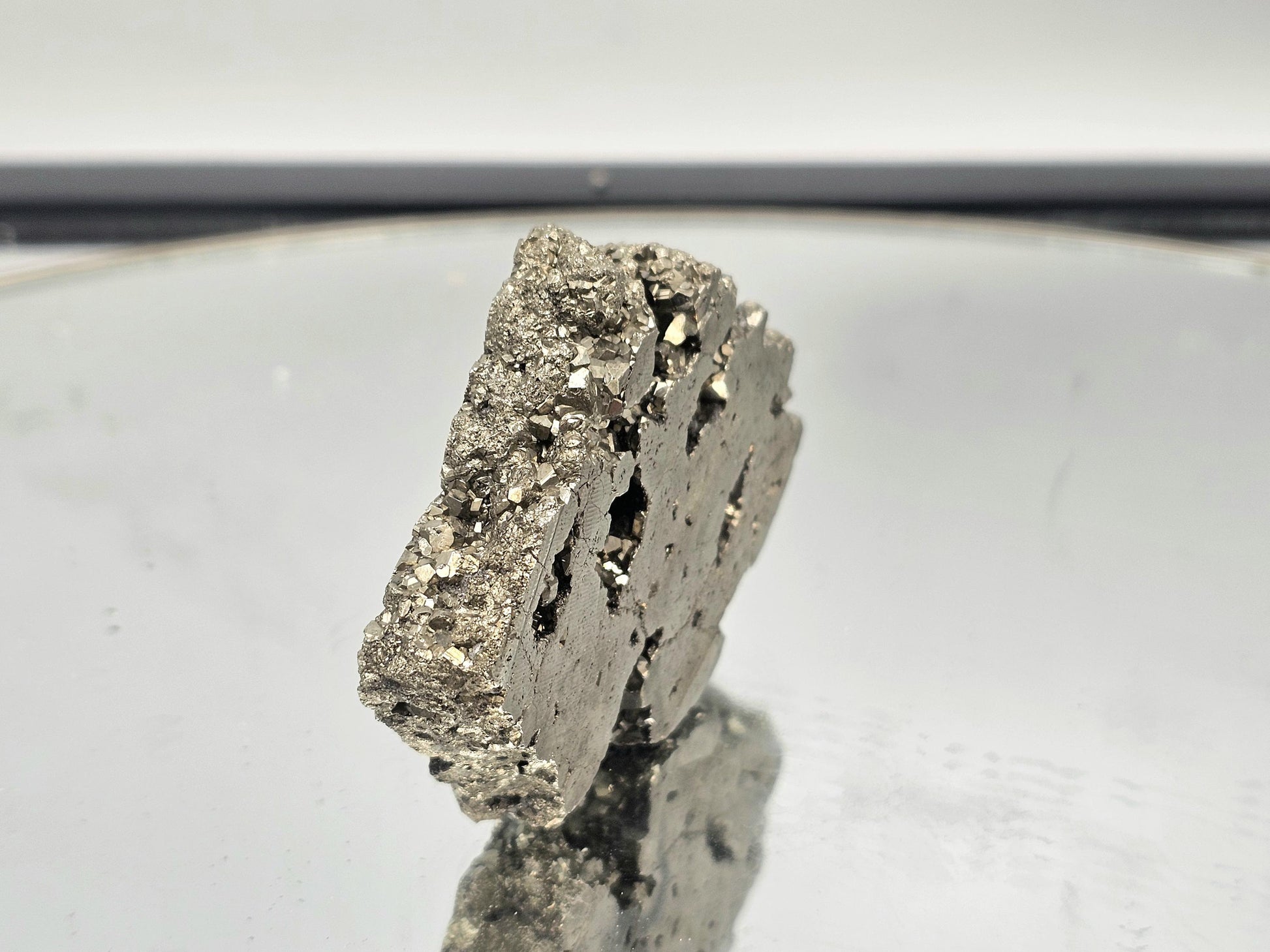 Natural Pyrite crystal slice with a shimmering gold finish.