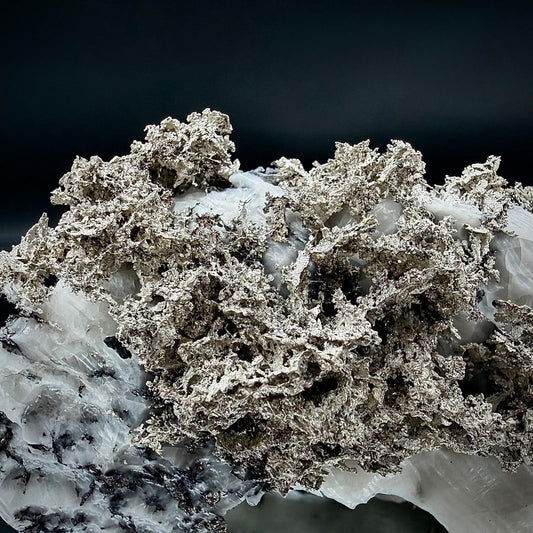 Natural mineral association of Native Silver and Calcite.