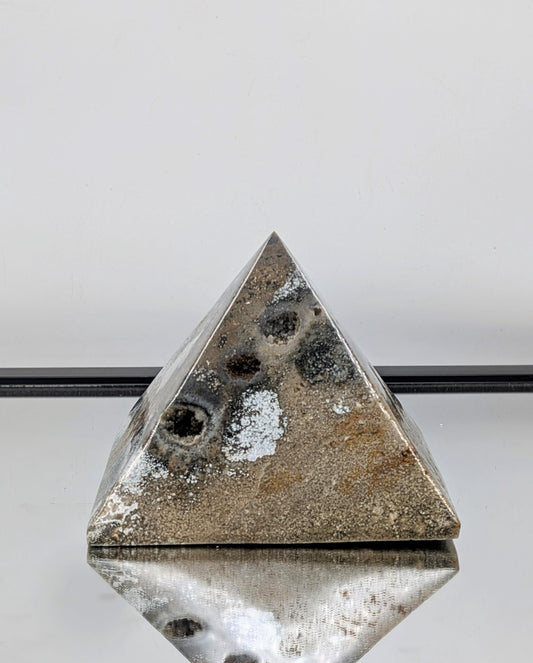 Hand-carved Ocean Jasper pyramid showcasing vibrant color and high polish.