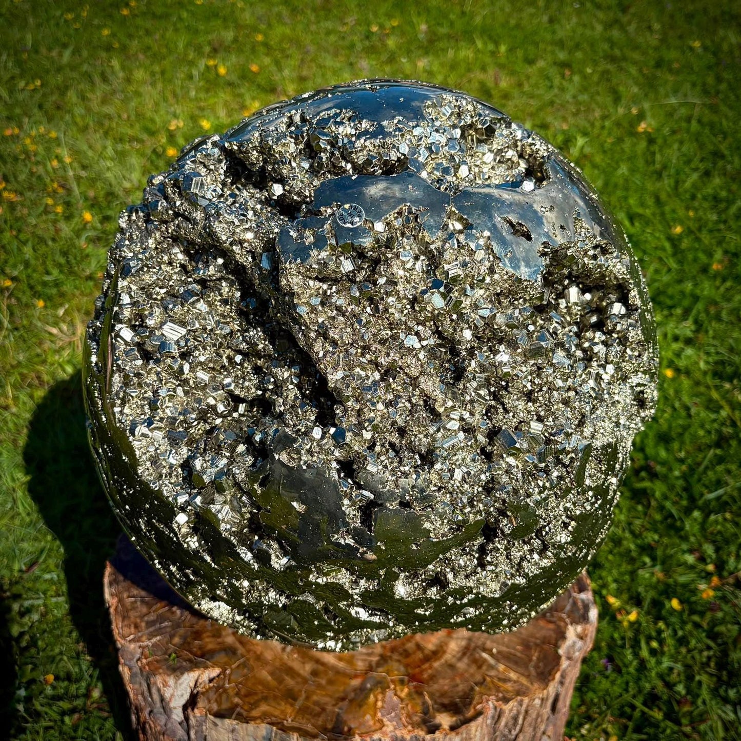 Detailed view of a Peruvian Pyrite sphere with bright metallic lustre and natural cube formations.