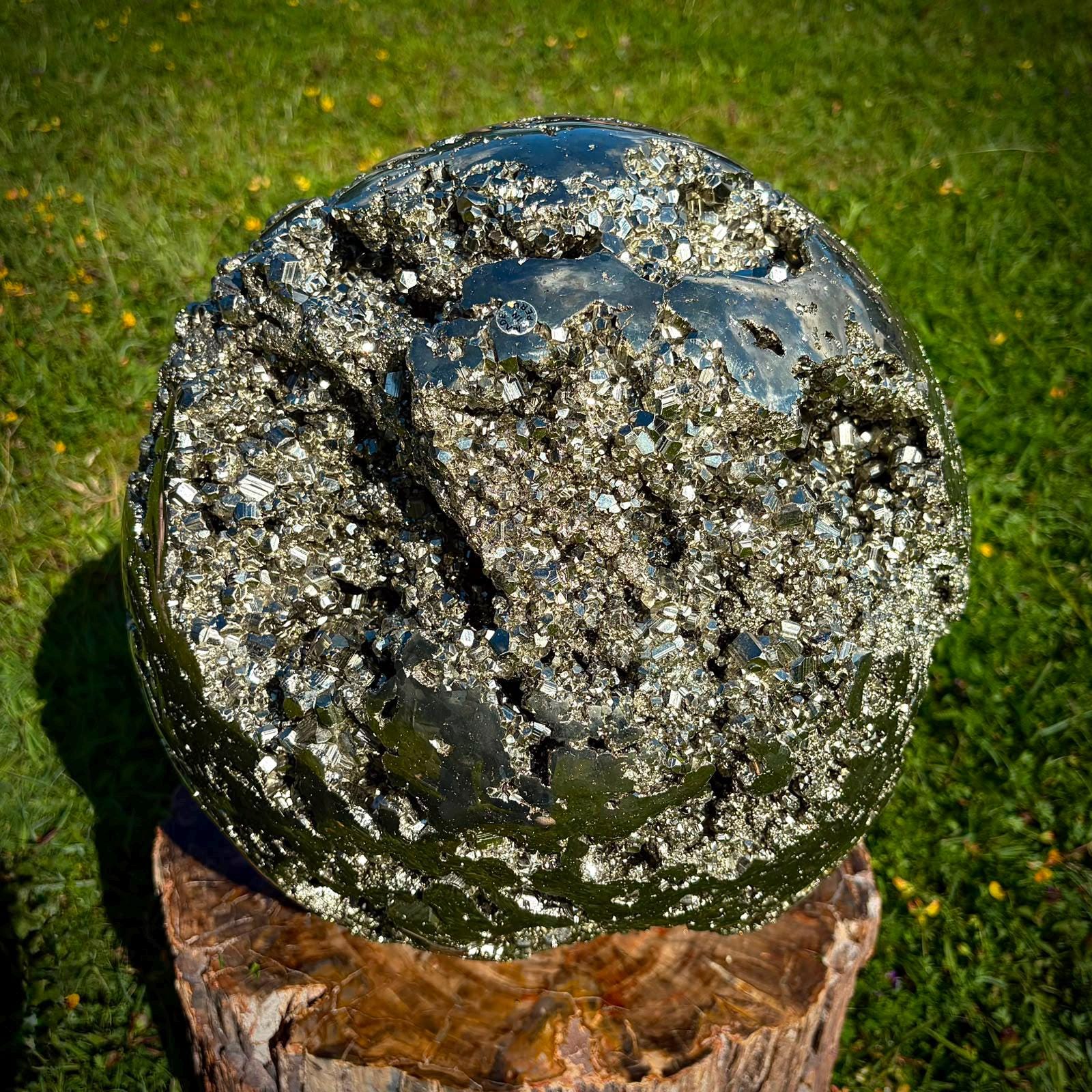 Detailed view of a Peruvian Pyrite sphere with bright metallic lustre and natural cube formations.