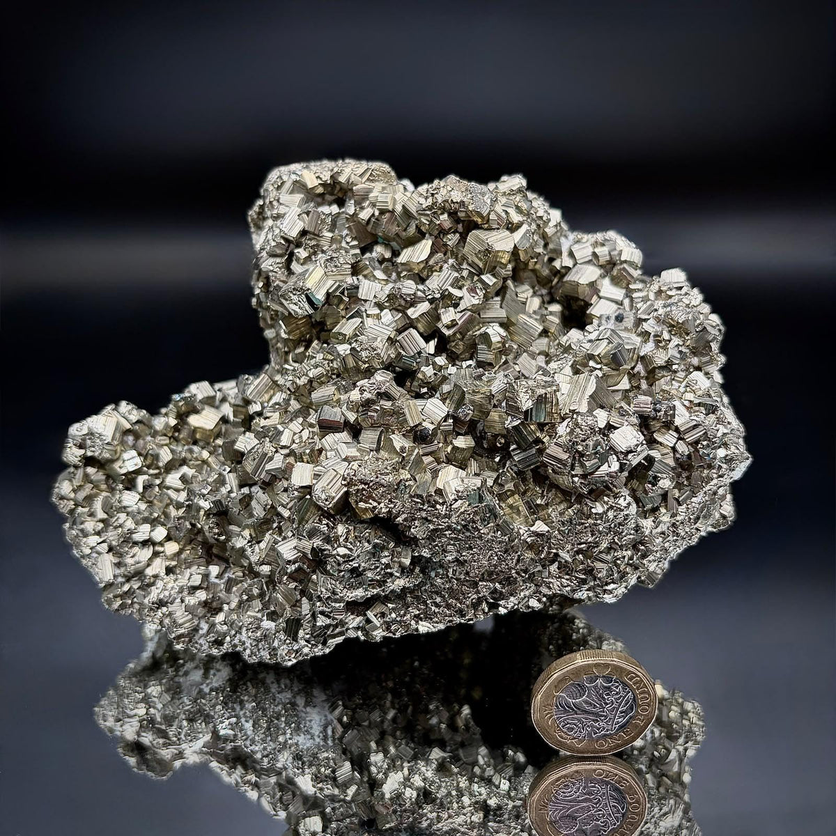 Side profile of a natural Peruvian Pyrite mineral specimen highlighting its three-dimensional crystal formation.