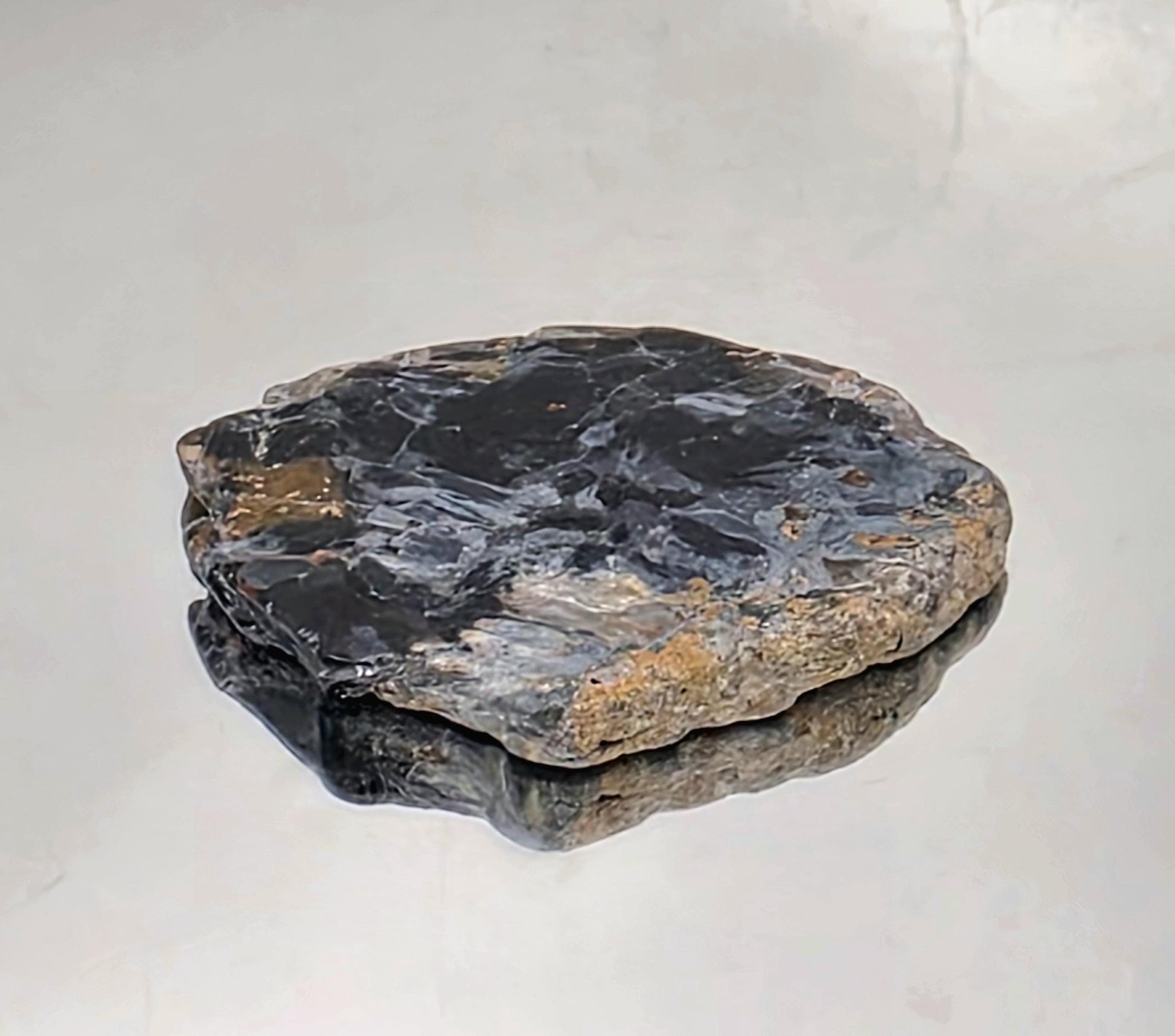 Pietersite slice showing golden and blue swirling patterns