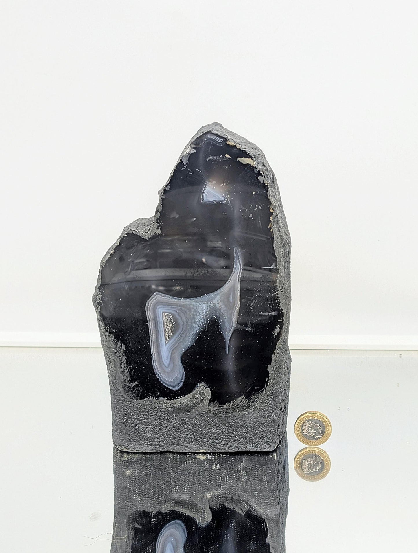Polished agate crystal geode with smooth outer surface
