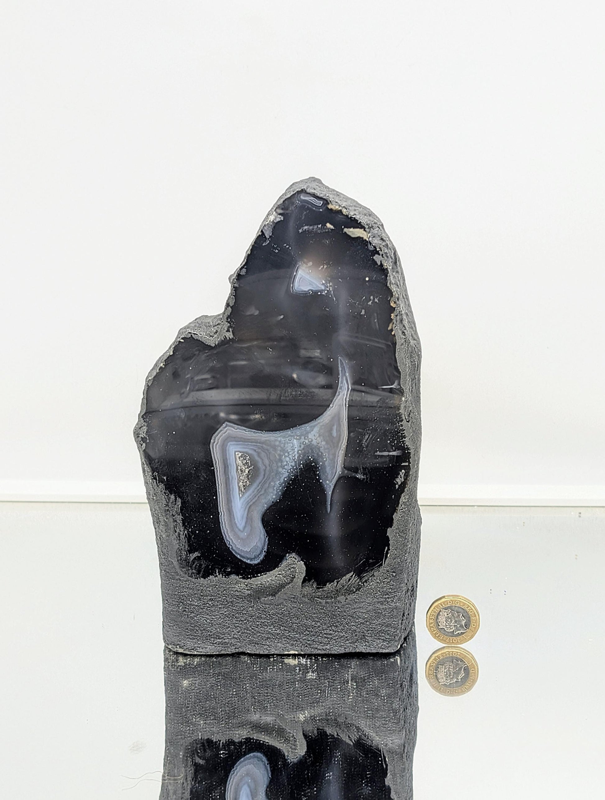 Polished agate crystal geode with smooth outer surface
