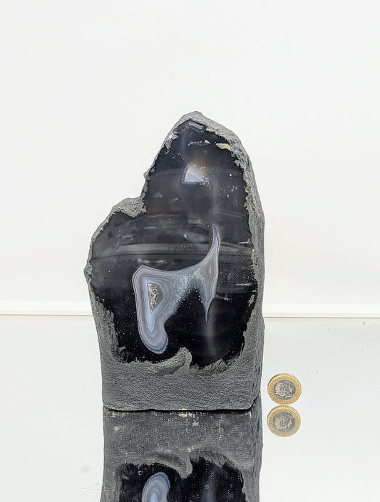 Polished agate crystal geode with smooth outer surface

