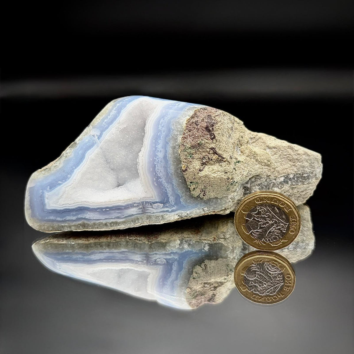 Polished Blue Lace Agate crystal geode displaying natural blue banding and druzy formation.