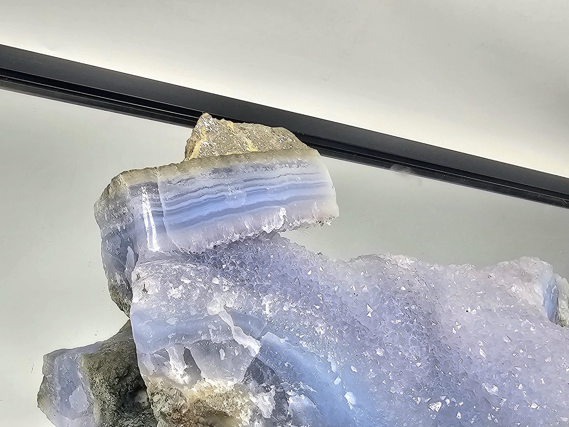 Stunning Blue Lace Agate geode displayed as part of an elegant home decor arrangement.