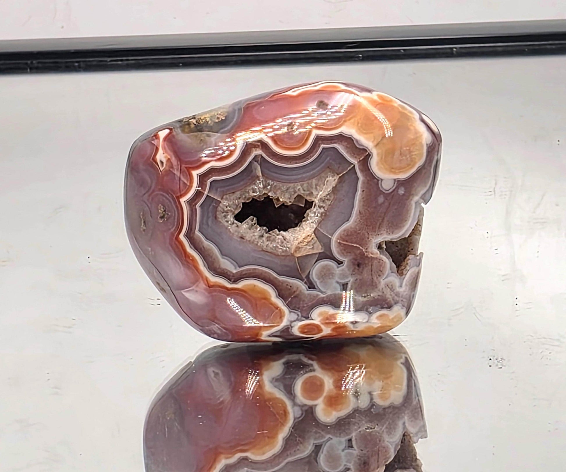 Polished crystal display Malawi Agate geode.