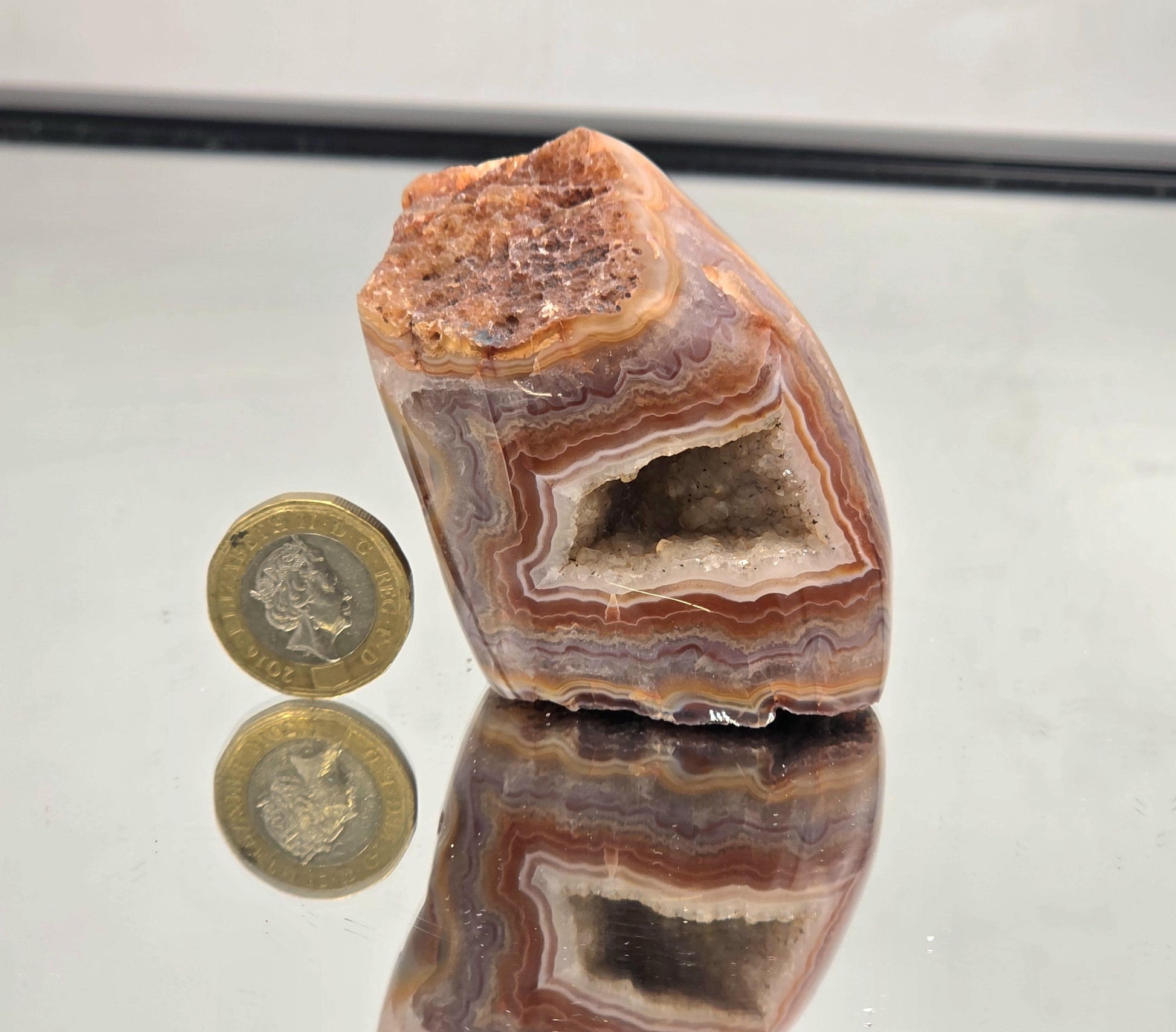 Polished Malawi Agate geode crystal with bands.