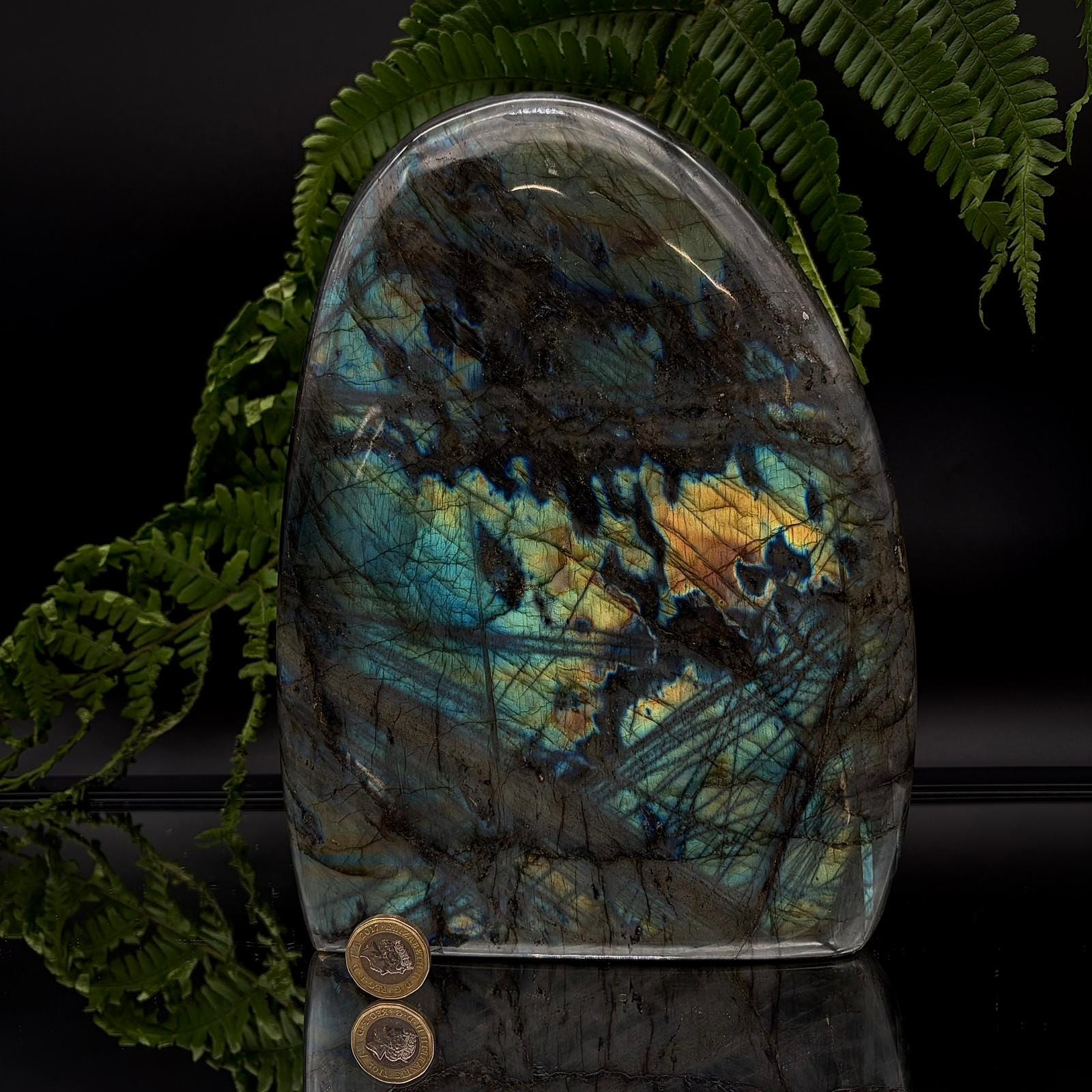 Polished labradorite freeform display stone with natural labradorescence and sculptural shape.