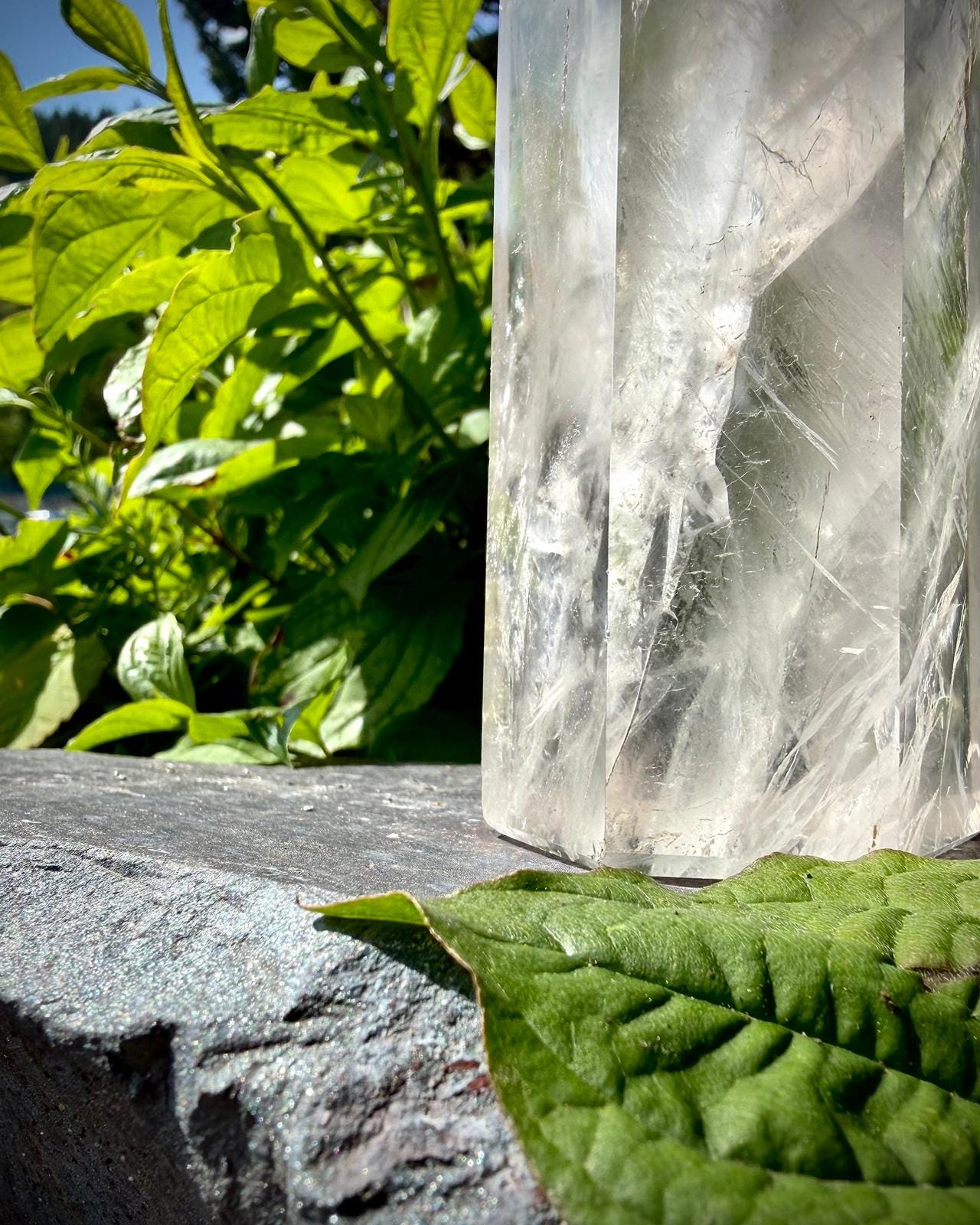 Polished Madagascar quartz crystal tower with clear tones and natural internal formations.