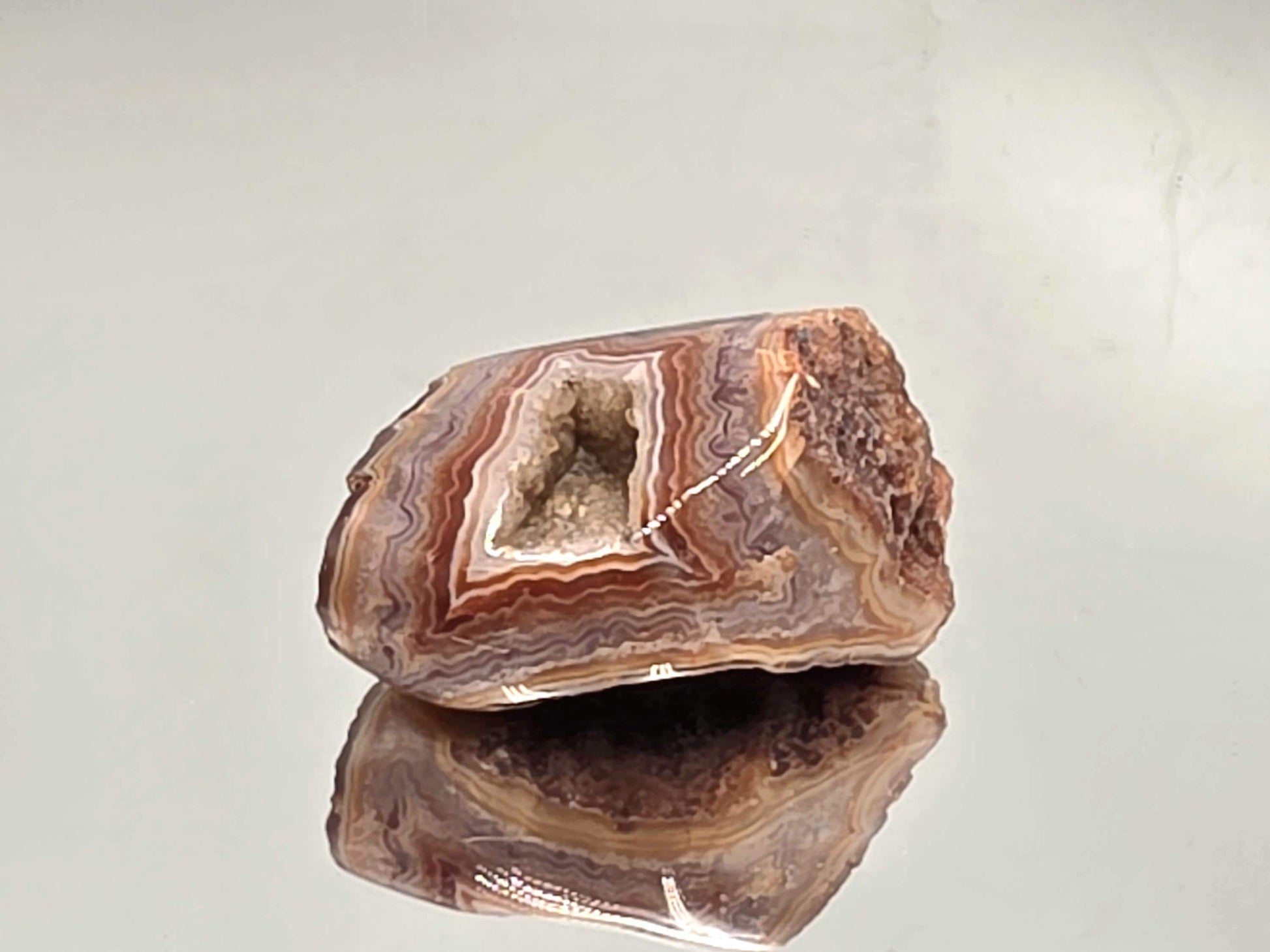 Polished Malawi Agate slice showing earthy layered tones.