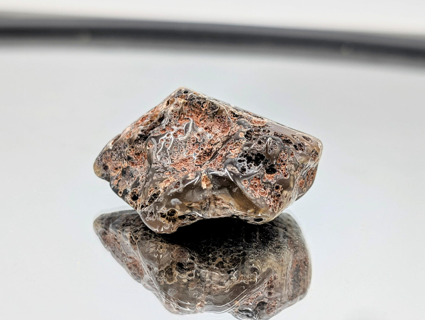 Polished Malawi Agate stone with intricate designs.