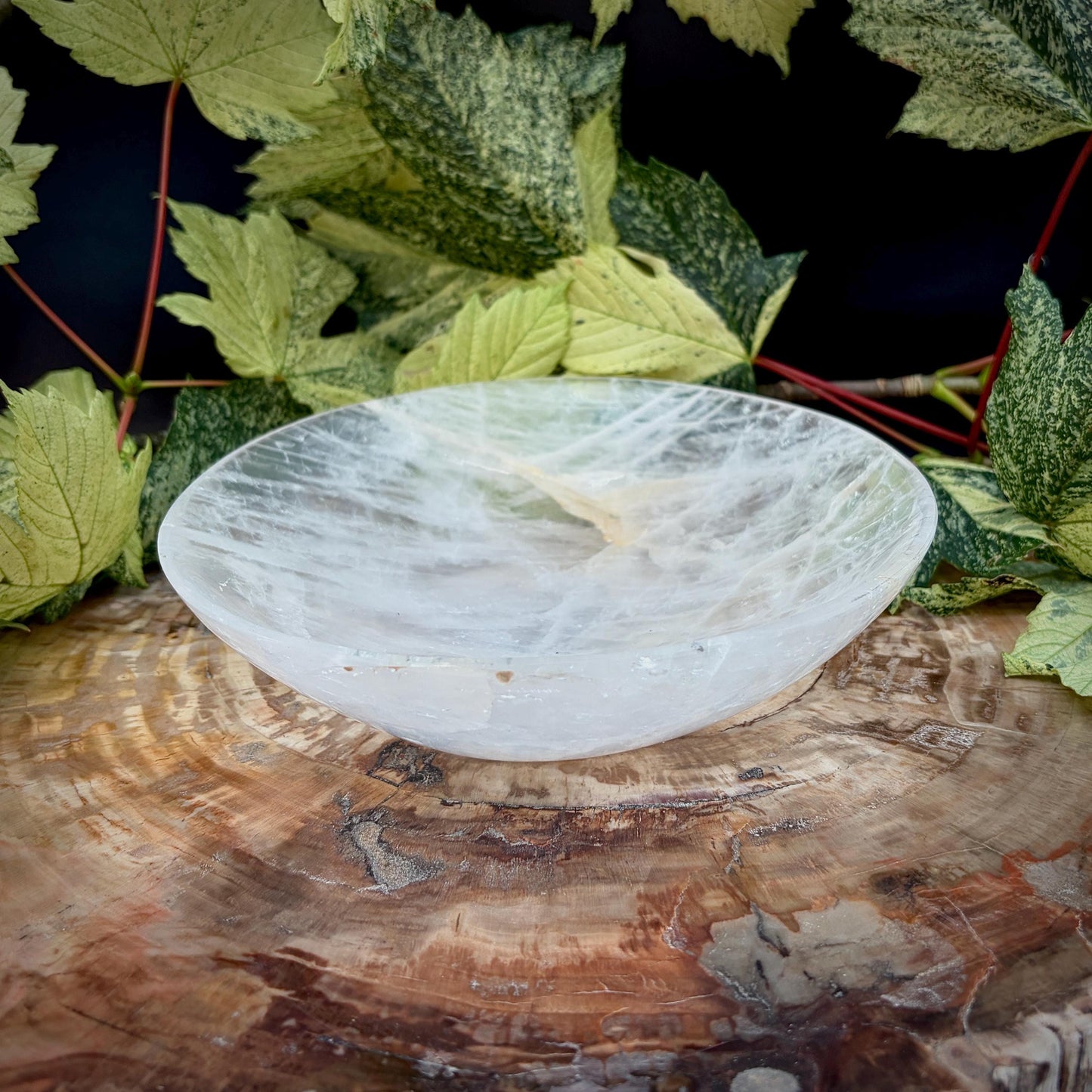 Polished Quartz crystal bowl displaying natural clarity and markings