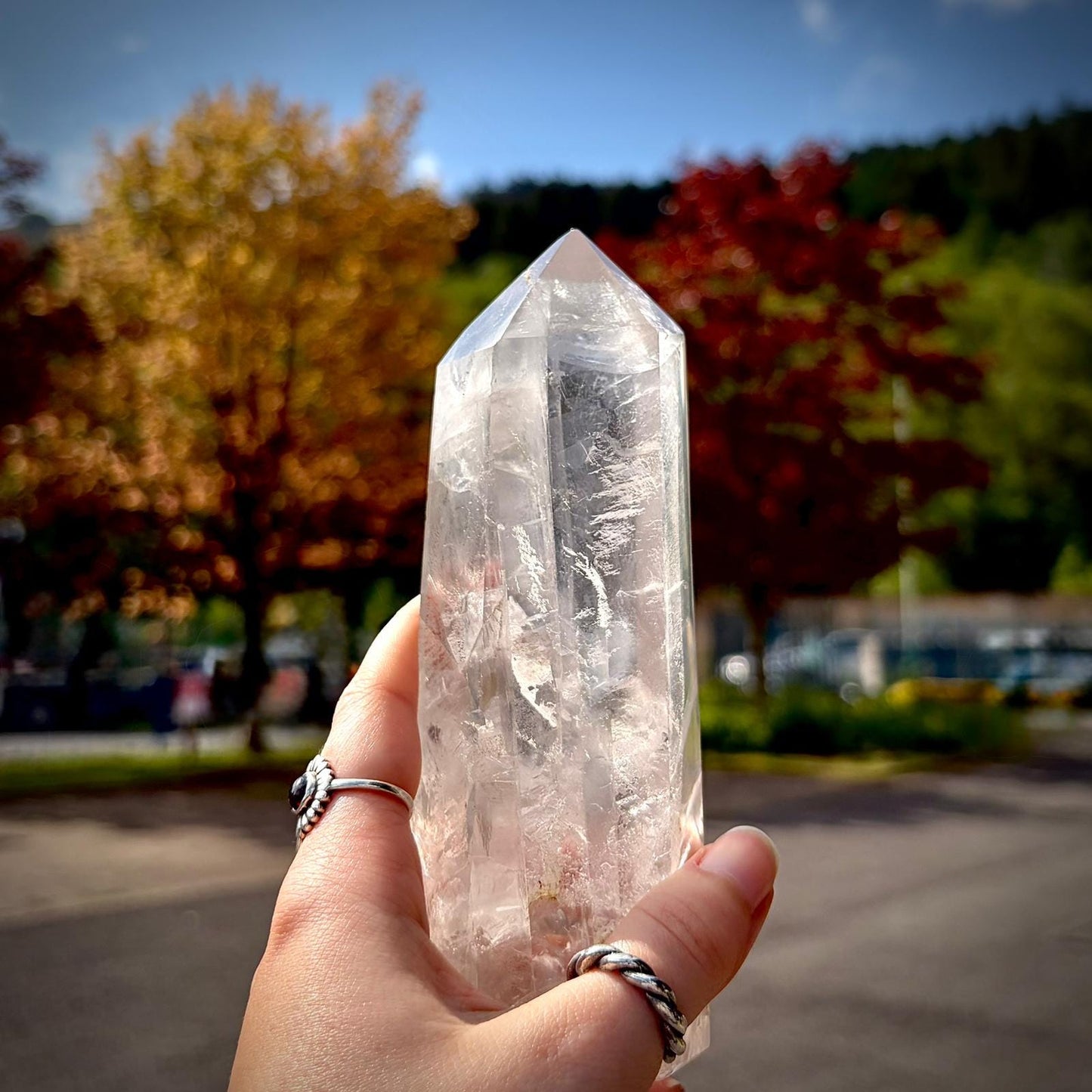 Polished quartz crystal prism tower with refined shape and natural mineral character.