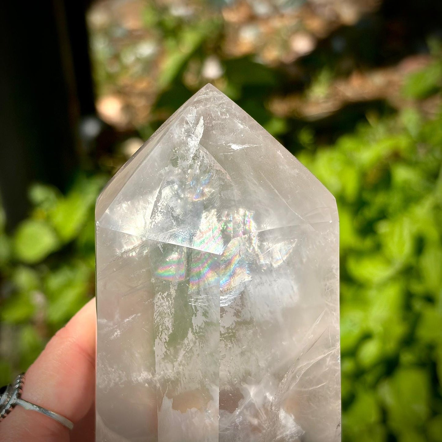 Polished quartz prism home decor piece with clear tones, natural veiling and elegant shape.