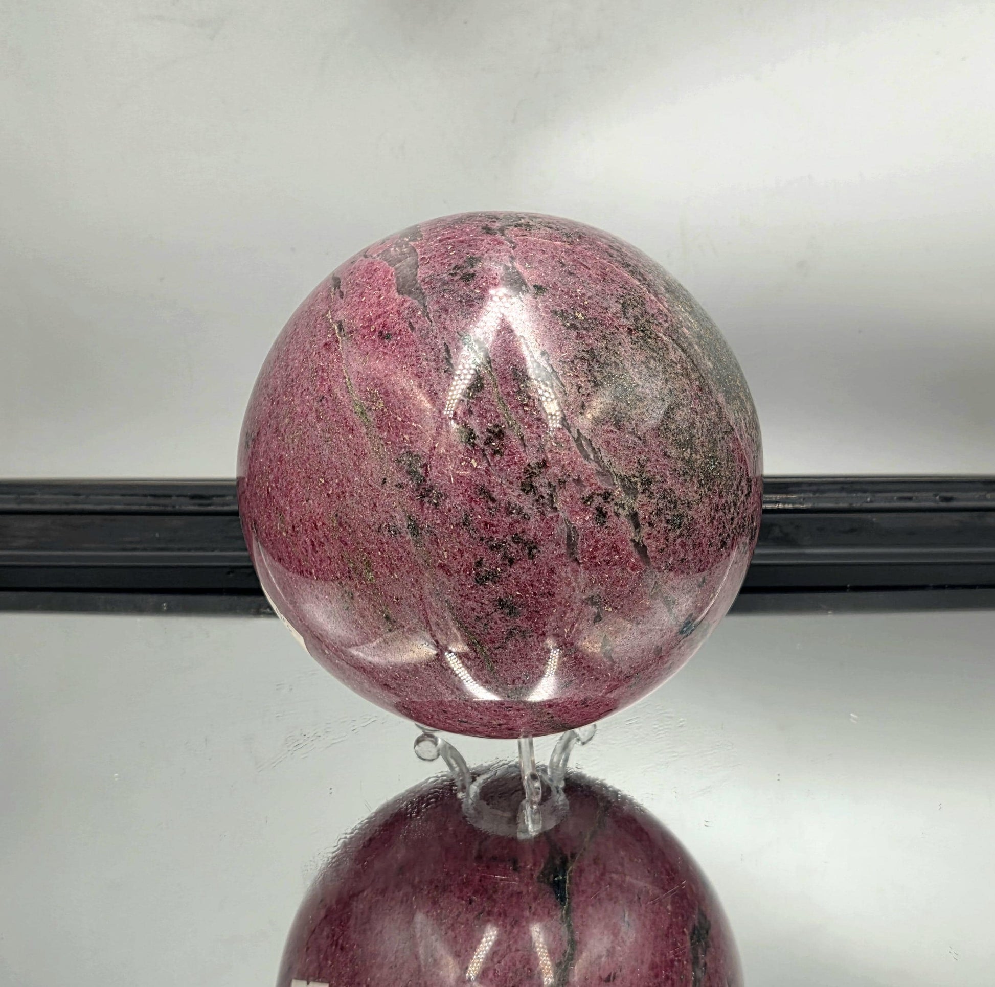High-polish rhodonite sphere perfect for collectors.
