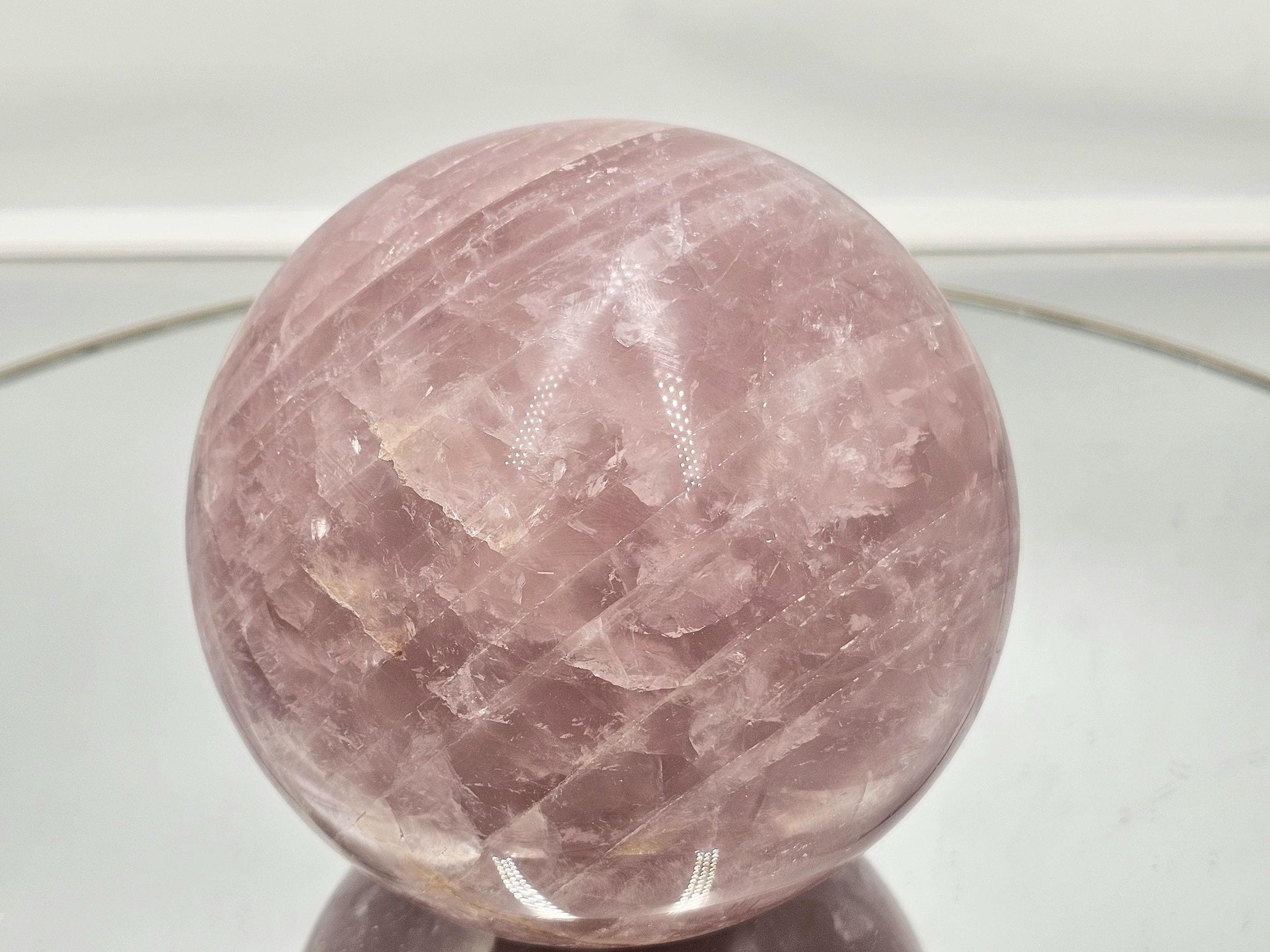 Premium polished star rose quartz crystal sphere with deep pink tones