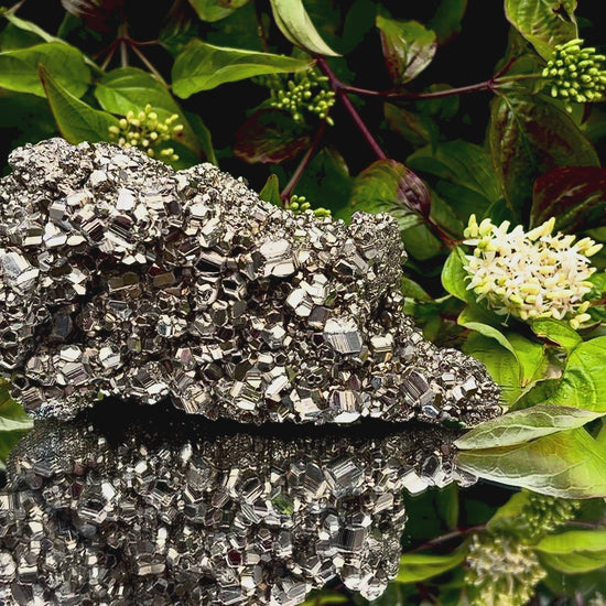 Video panning across a large Pyrite cluster to show its shimmering, light-reflecting crystals.