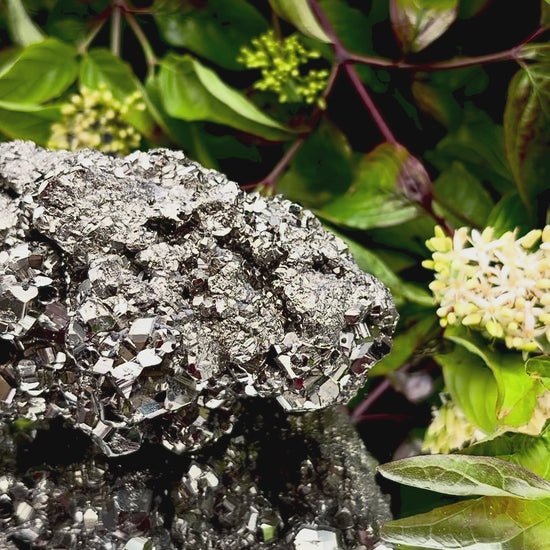 Video panning across a large Pyrite cluster to show its shimmering, light-reflecting crystals.