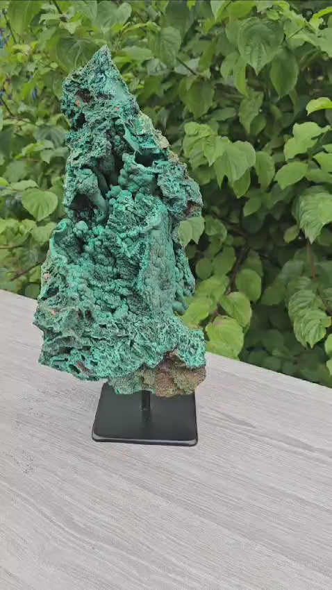 video of large malachite crystal on stand
