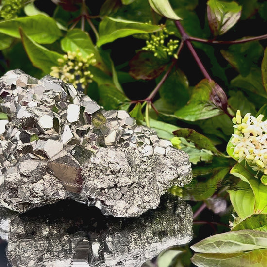 Video panning across a large Pyrite cluster to show its shimmering, light-reflecting crystals.