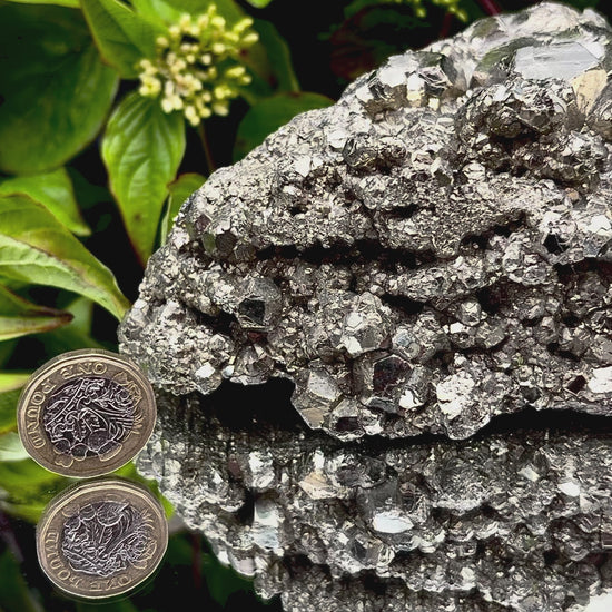 Video panning across a large Pyrite cluster to show its shimmering, light-reflecting crystals.
