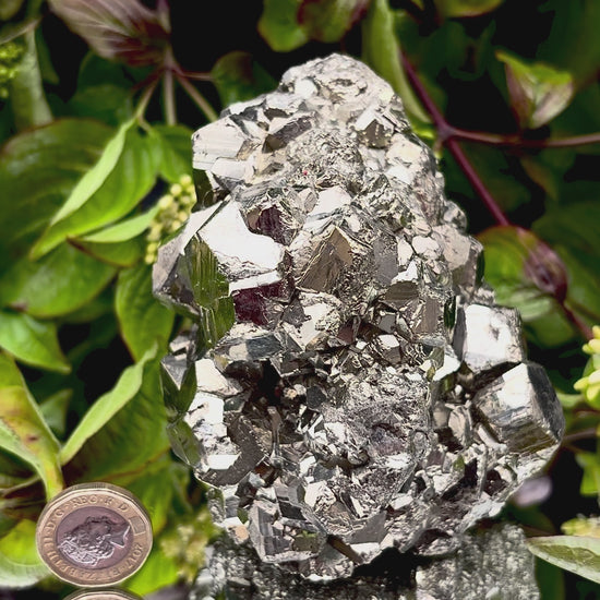 Video panning across a large Pyrite cluster to show its shimmering, light-reflecting crystals.