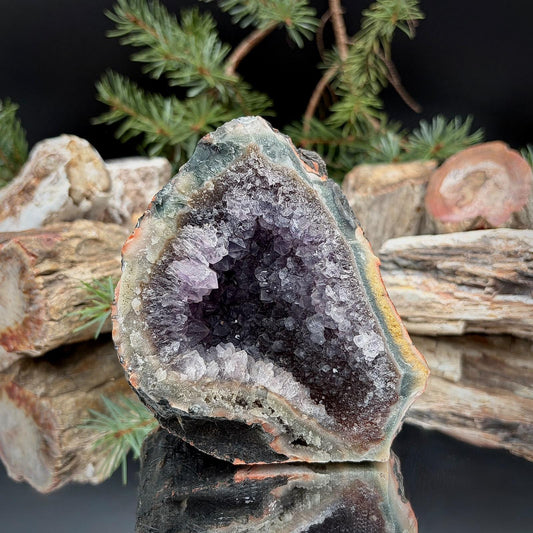 Natural purple Amethyst crystal cut base with exposed quartz crystals and a decorative freestanding form.