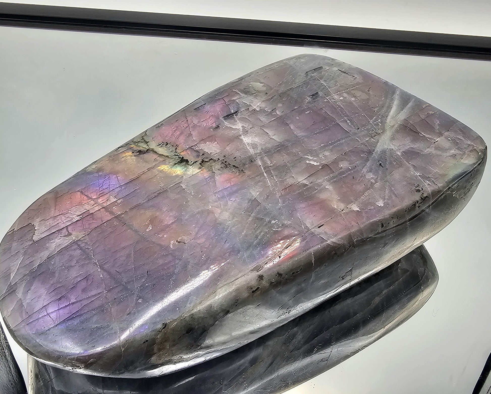 Fully polished Purple Labradorite crystal with a cut base.